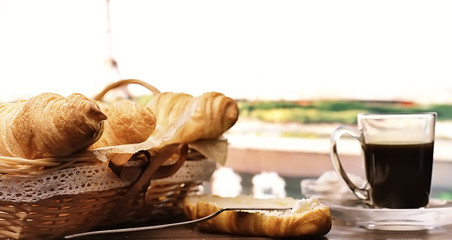 Fresh pastries on the table. French flavored croissant and coffee.