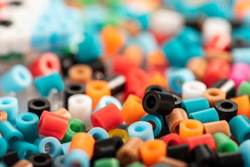 Set of colorful fusible beads close up. Known as perler beads. Toy that develops the imagination of...