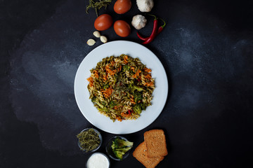 Delicious appetizing pasta. background with tomato sauce, broccoli, fresh vegetables and thyme, top view.
