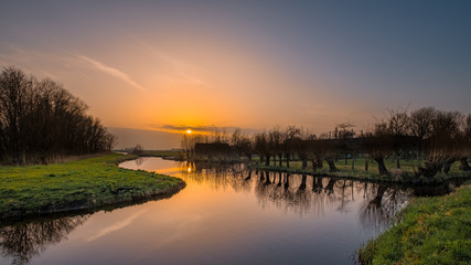 Naklejka na ściany i meble Sunset in the polder, close to Rotterdam Netherlands