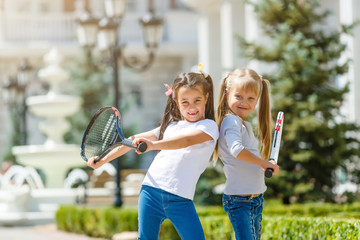 Obraz premium two little girls with tennis rackets