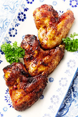 Spicy chicken wings with fresh herbs. Top view. 