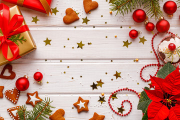 Christmas background, composition with gift boxes, christmas balls, gingerbread cookies and christmas accessories on a white wooden background, top view, copy space.