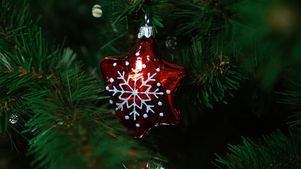 Christmas decorations on the Christmas tree. Ball in the form of snowflakes.