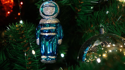 Christmas decorations on the Christmas tree. Blue astronaut.