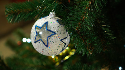 Christmas decorations on the Christmas tree. A ball with a star.