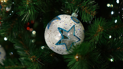Christmas decorations on the Christmas tree. A ball with a star.