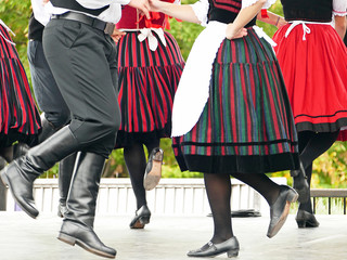Hungarian folk dancers dancing in black, white and red in a traditional festival
