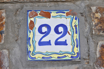 A house number plaque, showing the number twenty two (22)