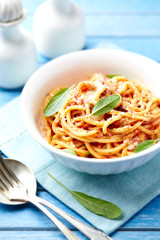 Spaghetti pasta in a small bowl. Bright background. 