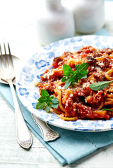 Spaghetti pasta with zucchini in a small bowl. Bright background.