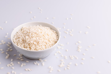 Italian Risotto rice on white background. Copy Space. Soft light. Latin term 