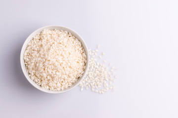 Italian Risotto rice on white background. Copy Space. Soft light. Latin term "Oryza sativa". Carnaroli rice. Vialone Nano rice.