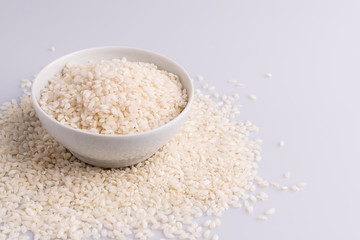 Italian Risotto rice on white background. Copy Space. Soft light. Latin term "Oryza sativa". Carnaroli rice. Vialone Nano rice.