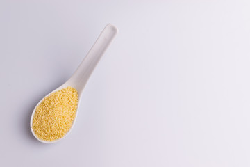 Dry couscous isolated on white background, soft light, copy space.