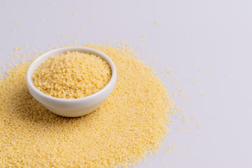 Dry couscous isolated on white background, soft light, copy space.