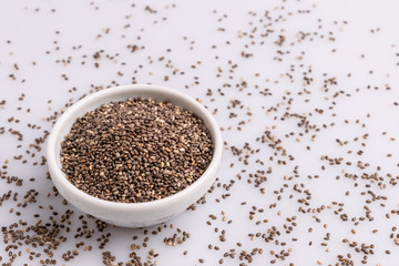 Chia seeds  isolated on white background, angle view, copy space, studio shot, soft light. Latin name (Salvia hispanica).