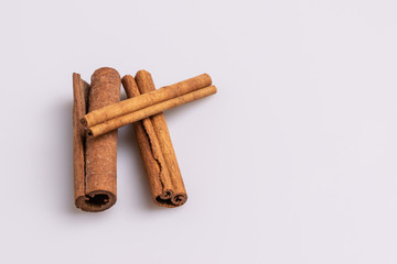 Cinnamon sticks isolated on white background, copy space, studio shot, soft light, top view.  Latin name  Cinnamomum cassia