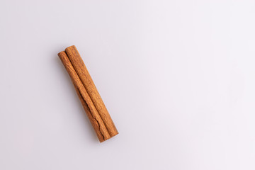 Cinnamon sticks isolated on white background, copy space, studio shot, soft light, top view.  Latin name  Cinnamomum cassia