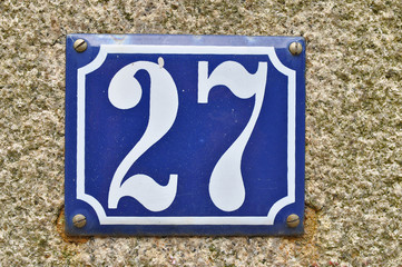 A house number plaque, showing the number twenty seven (27)