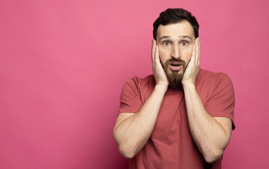 Bearded Man with shocked, amazed expression isolated on pink background
