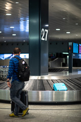 Unclaimed luggage concept - suitcase going around on the conveyor belt at an international airport, at the baggage claim zone - motion blurred image