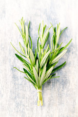 Fresh rosemary on rustic wooden background. Top view. 