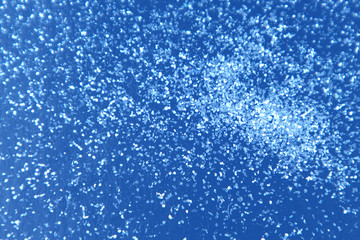 Naklejka na ściany i meble Abstract background glitter snow on classic blue surface.