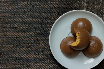 Honey bread cookie, typical Brazilian candy with cup of coffee on wooden background
