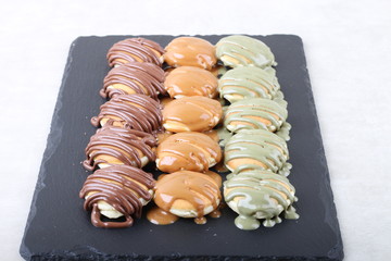 small pancake with chocolate and pistachio - top view on a texture background 