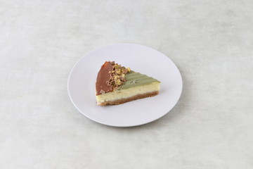 cheesecake with pistachio and nuts - cheese cake isolated on a wooden background 