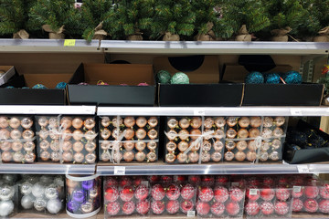 Balls to decorate the Christmas tree. Christmas balls on the counter in plastic containers.