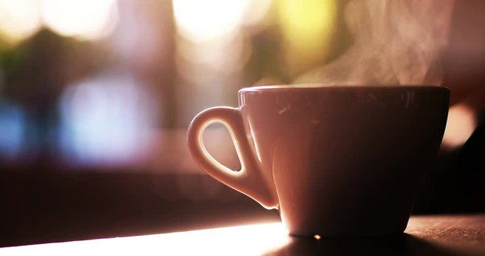 Close up 4K shot of a hot coffee cup with steam coming out of it, in a morning, in Bucharest, Romania.