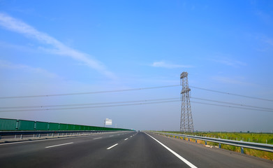 Beautiful highway, under the blue sky and white clouds