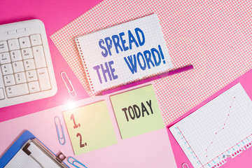 Conceptual hand writing showing Spread The Word. Concept meaning share the information or news using social media Writing equipments and computer stuffs placed on plain table