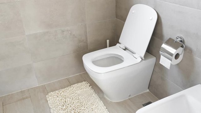 White ceramic toilet and bidet at luxury bathroom, nobody