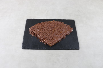 crepe with chocolate sauce and nutella pistachio  on white background