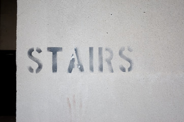 Stairs sign on wall