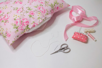 Materials and accessories for handmade. The process of hand sewing with fabric, scissors, accessories for sewing. Sewing pillows