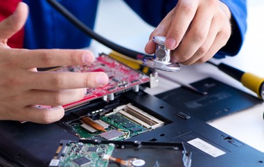 Repairman working in technical support fixing computer laptop tr