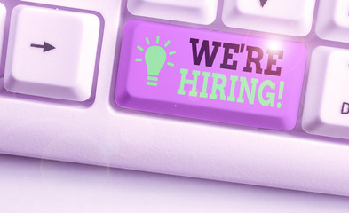 Writing note showing We Re Hiring. Business concept for recently employ someone or pay someone to...