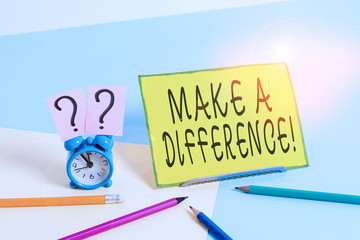 Conceptual hand writing showing Make A Difference. Concept meaning have significant effect or non on demonstrating or situation Mini size alarm clock beside stationary on pastel backdrop
