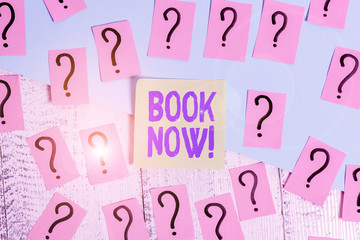 Conceptual hand writing showing Book Now. Concept meaning guaranteed to have place because you have already purchased it Crumbling papers with thick cardboard on the wooden table