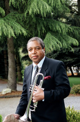 African american male trumpet player outdoors.