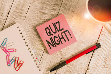 Writing note showing Quiz Night. Business concept for evening test knowledge competition between individuals Stationary placed next to a cup of black coffee above the wooden table