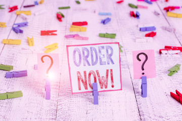 Writing note showing Order Now. Business concept for confirmed request by one party to another to buy sell Crumbling sheet with paper clips placed on the wooden table