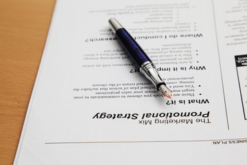 Business plan completed with pen and notebook 