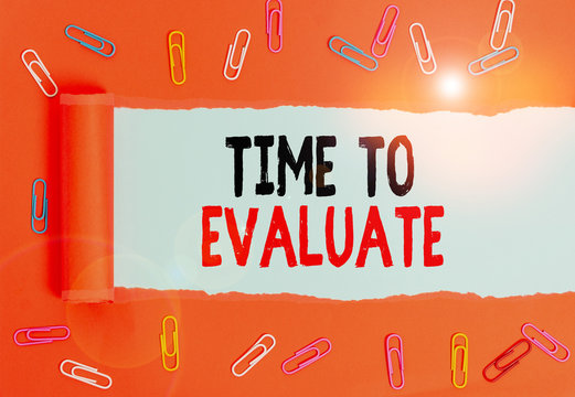 Writing note showing Time To Evaluate. Business concept for judge something with respect to its worth or significance Paper clip and torn cardboard on wood classic table backdrop