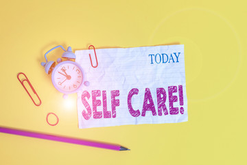 Word writing text Self Care. Business photo showcasing practice of taking action to preserve or improve ones own health Alarm clock clips crushed note rubber band pencil colored background
