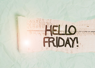 Text sign showing Hello Friday. Business photo text used to express happiness from beginning of fresh week Cardboard which is torn in the middle placed above a wooden classic table